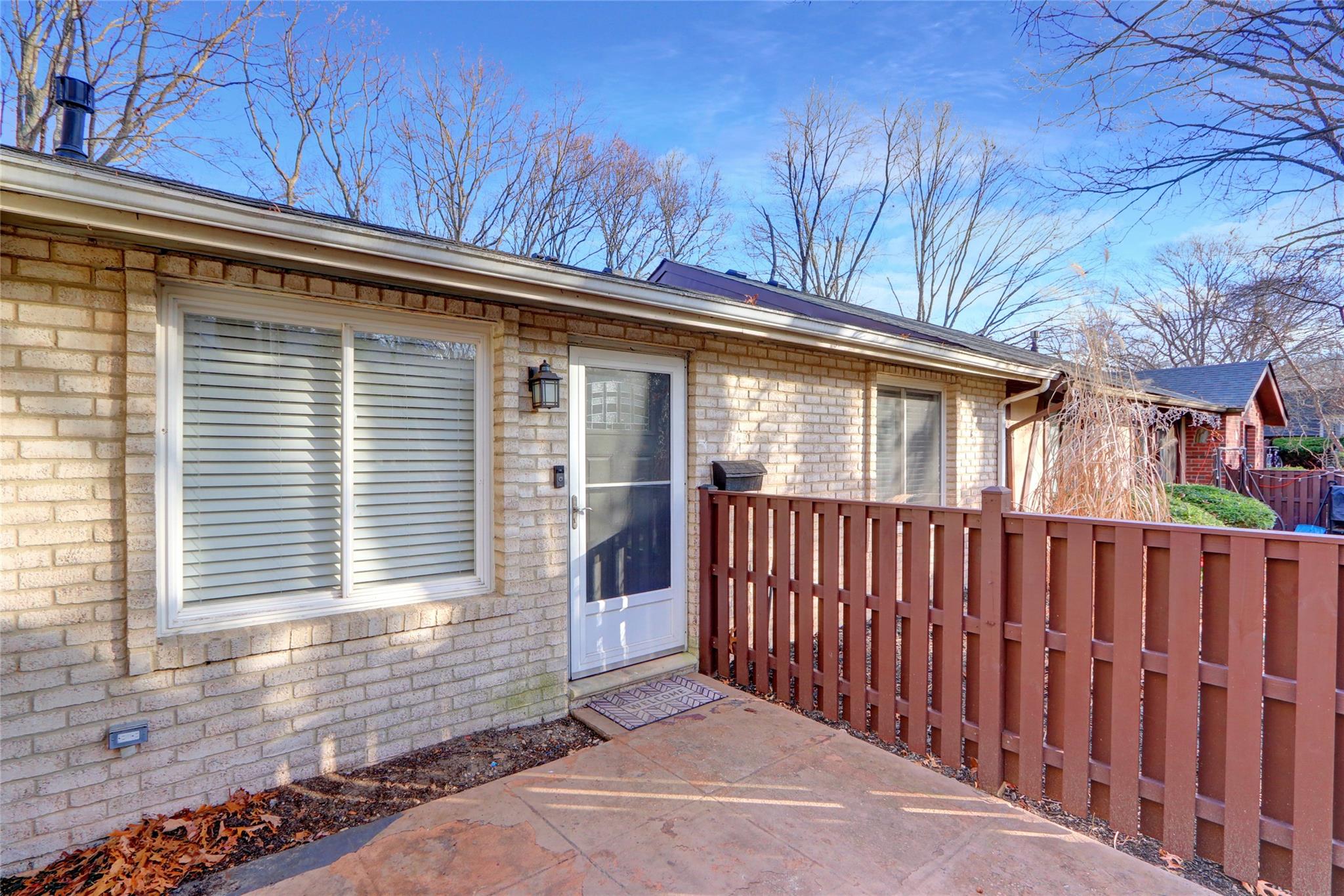 View of exterior entry featuring a patio