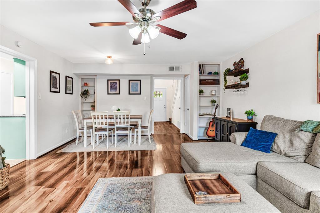 a living room with furniture and a wooden floor