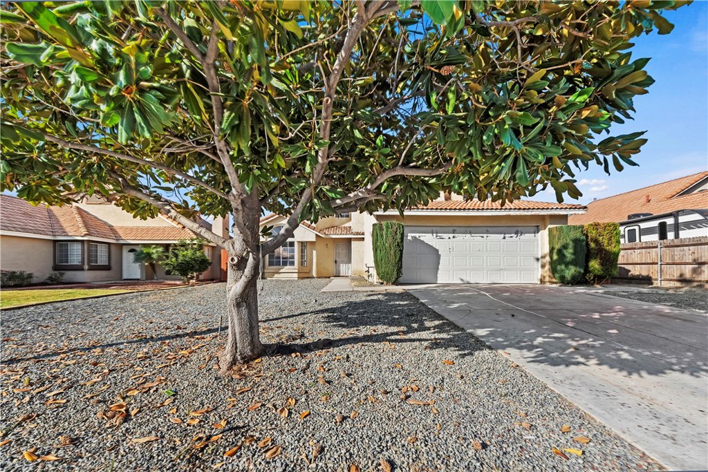 a front view of a house with a yard and a garage