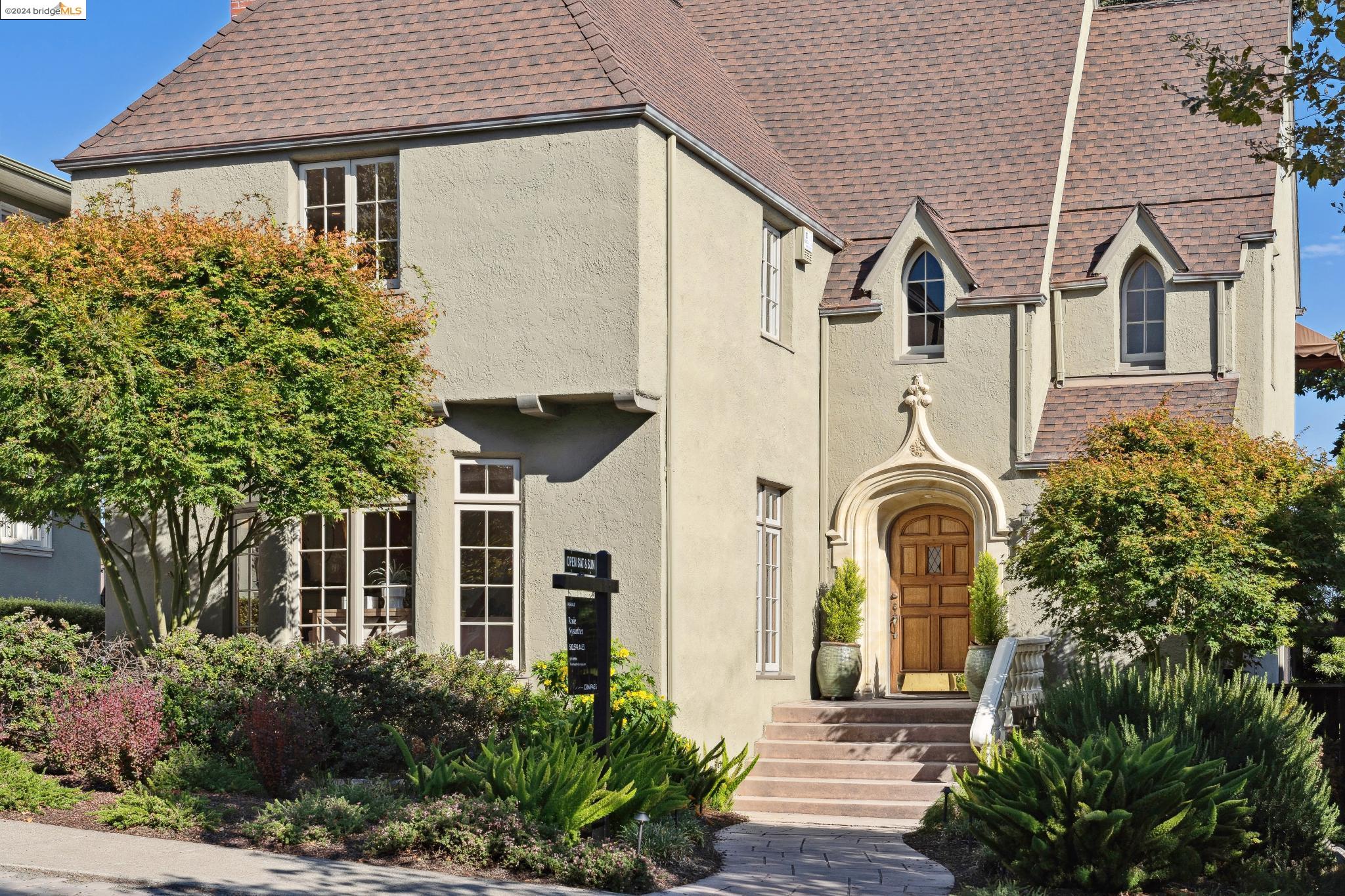 a front view of a house with garden