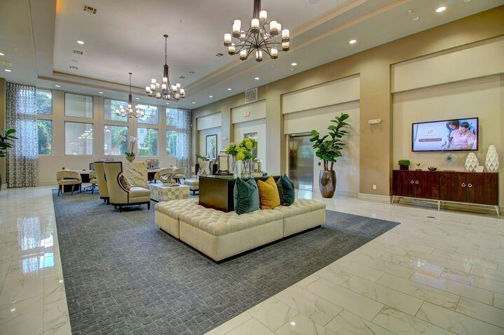 a living room with furniture and a chandelier