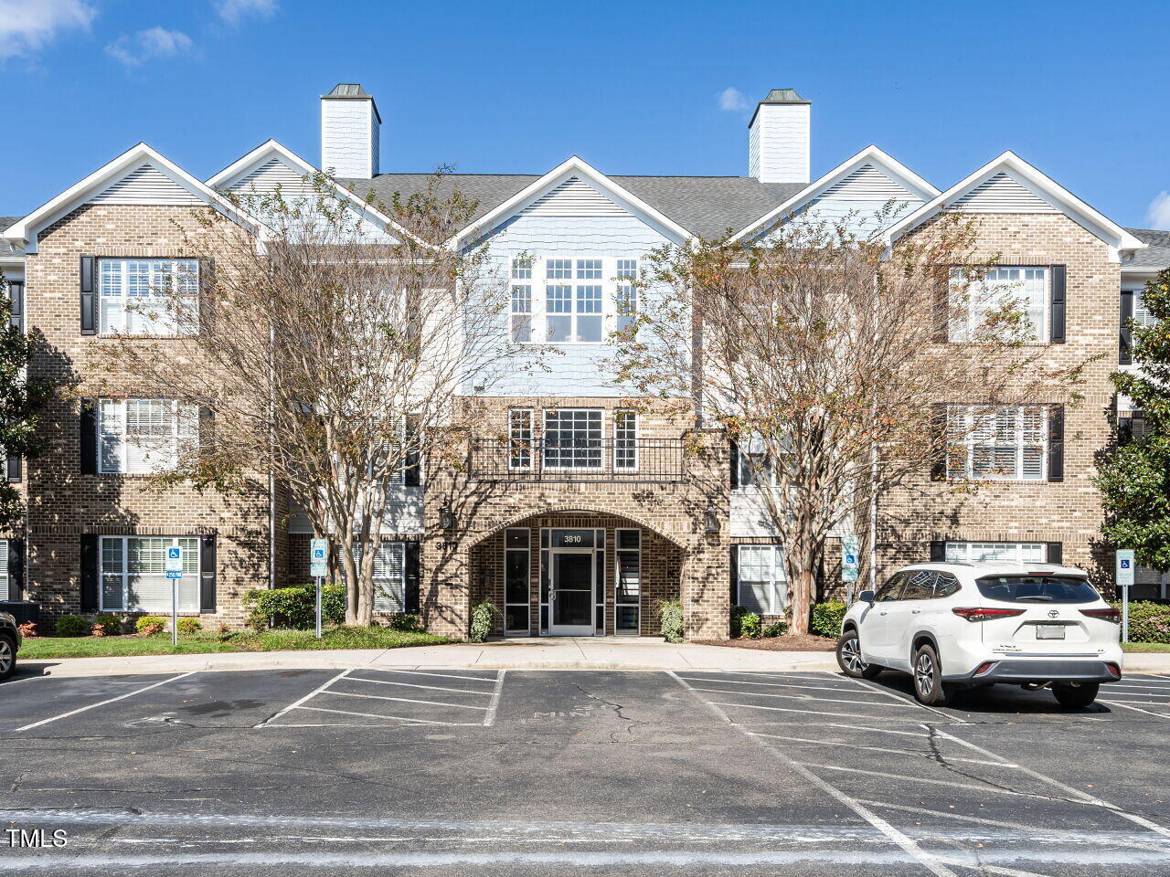 a front view of a residential apartment building with a yard