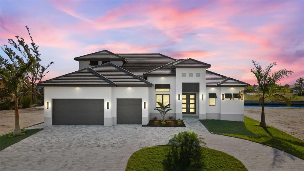 front view of a house with a yard and garage