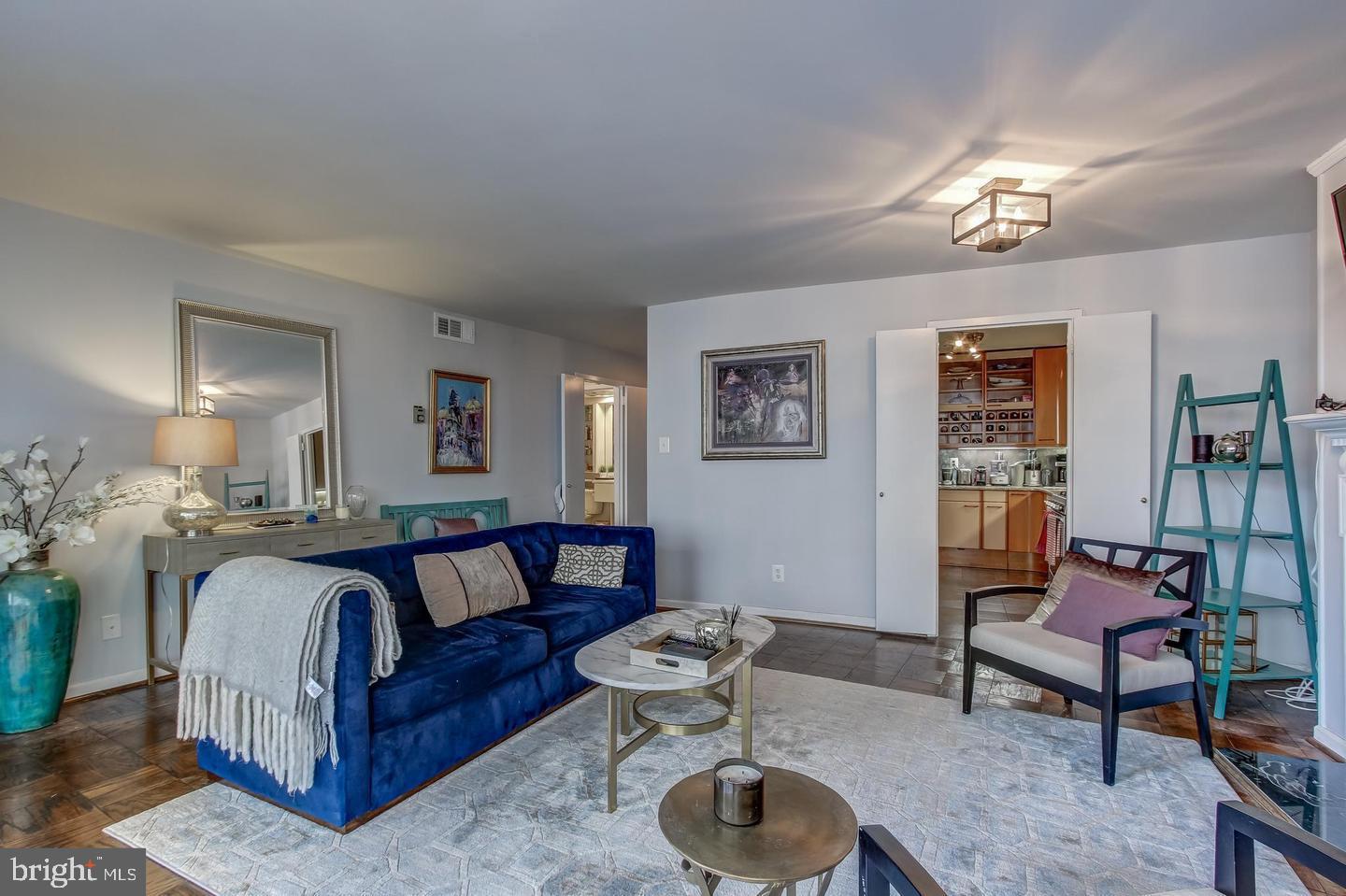 a spacious bedroom with a bed and a chandelier