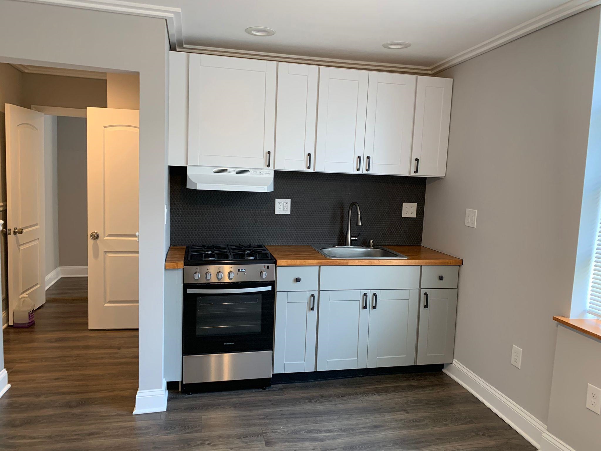 a kitchen with a sink and a stove top oven