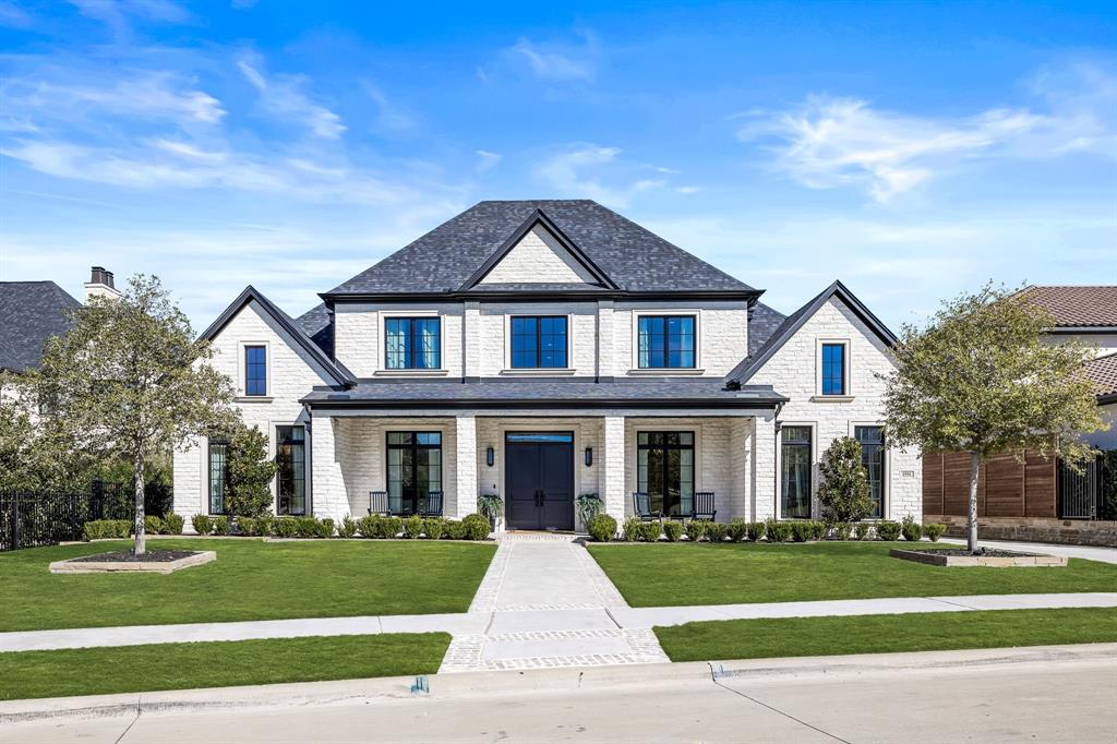 front view of a brick house with a yard