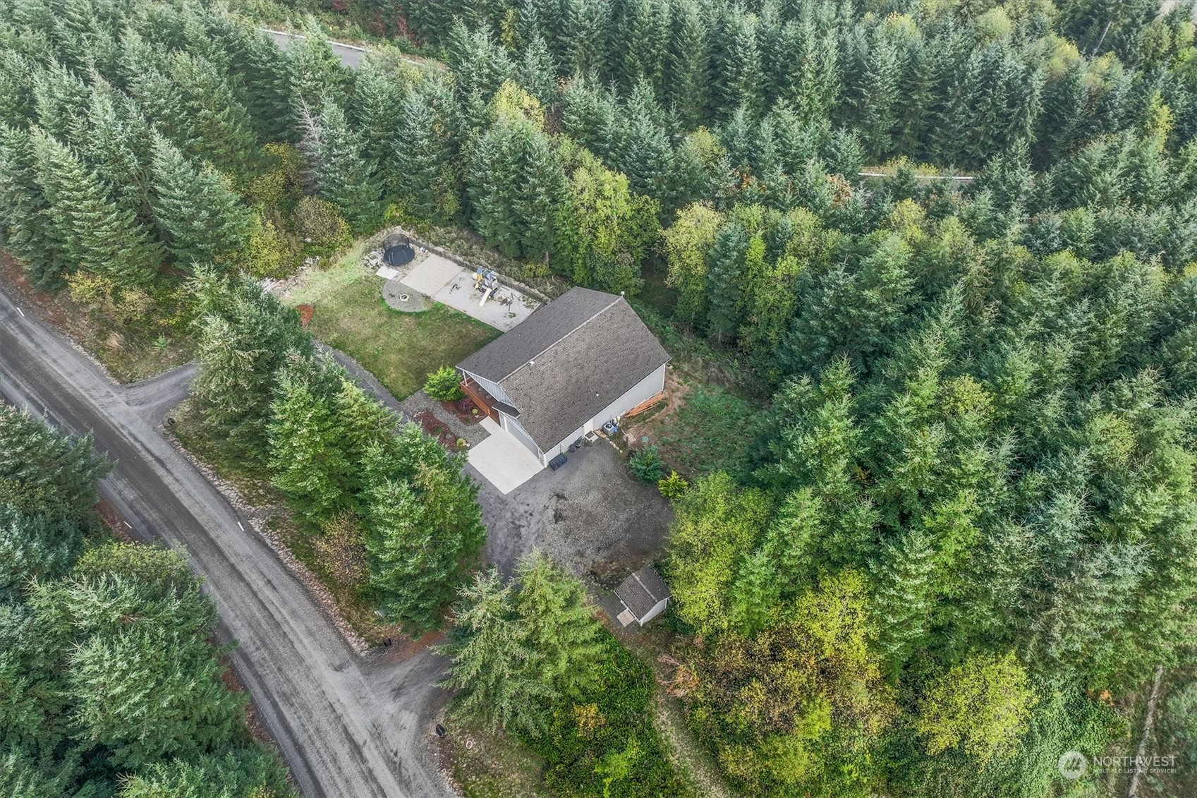 an aerial view of a house with a yard