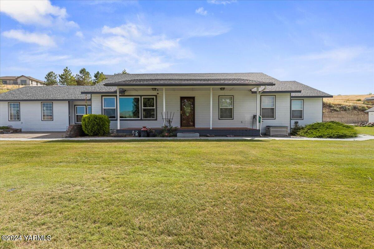 a front view of house with yard and outdoor seating