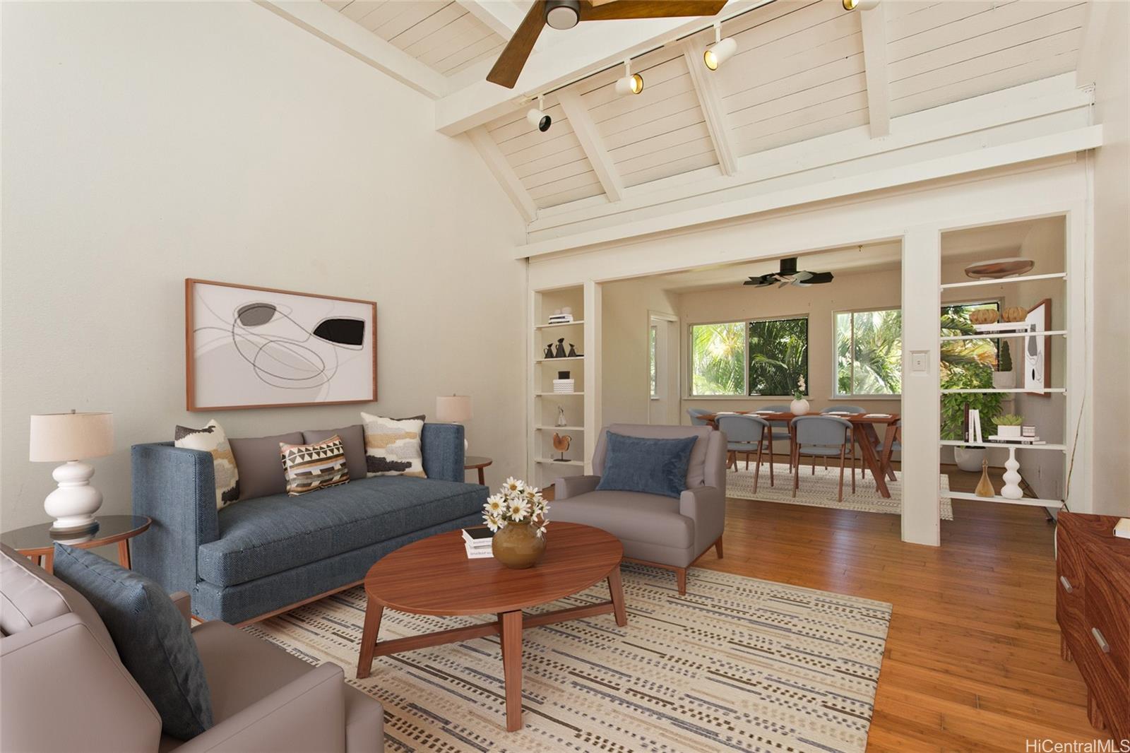 a living room with furniture and wooden floor