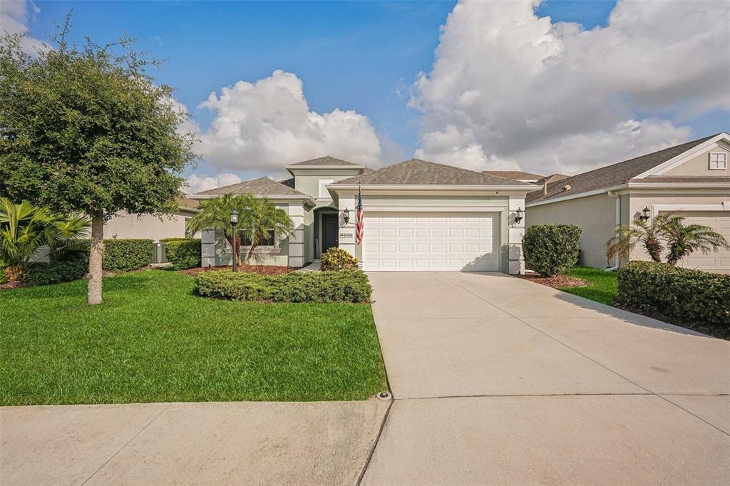 a front view of a house with a yard and garage