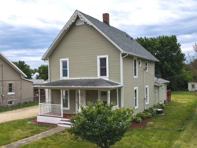 a front view of a house with a yard