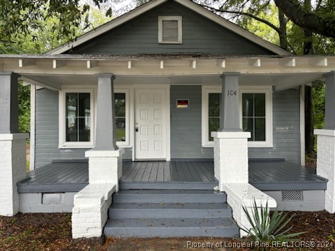 a front view of a house with outdoor seating