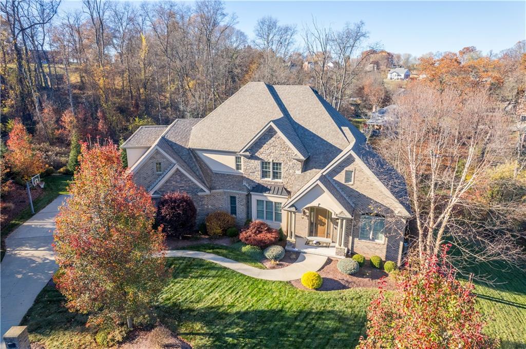 a aerial view of a house with swimming pool and garden