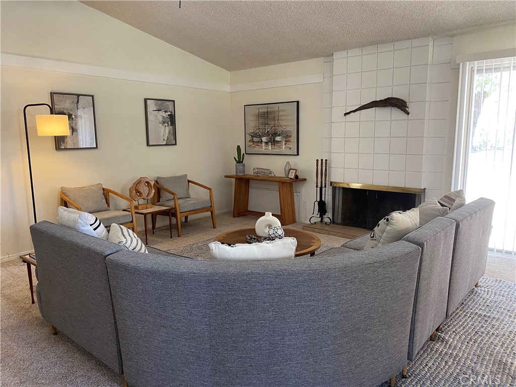 a living room with furniture a couch and a window