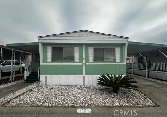 a front view of a house with a glass windows and table