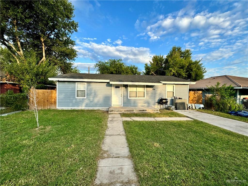 a view of backyard of house with green space