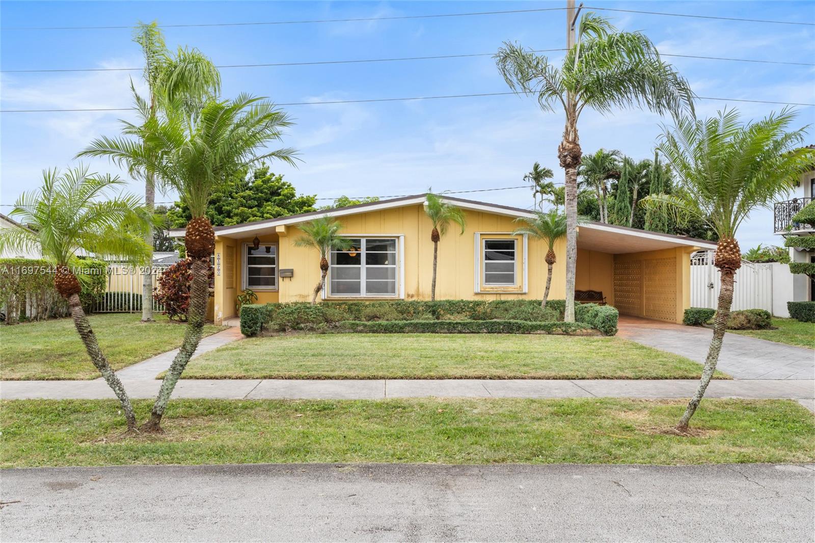 a house that has a tree in front of it