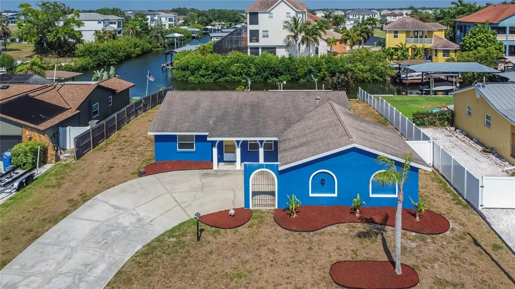 an aerial view of a house with a yard