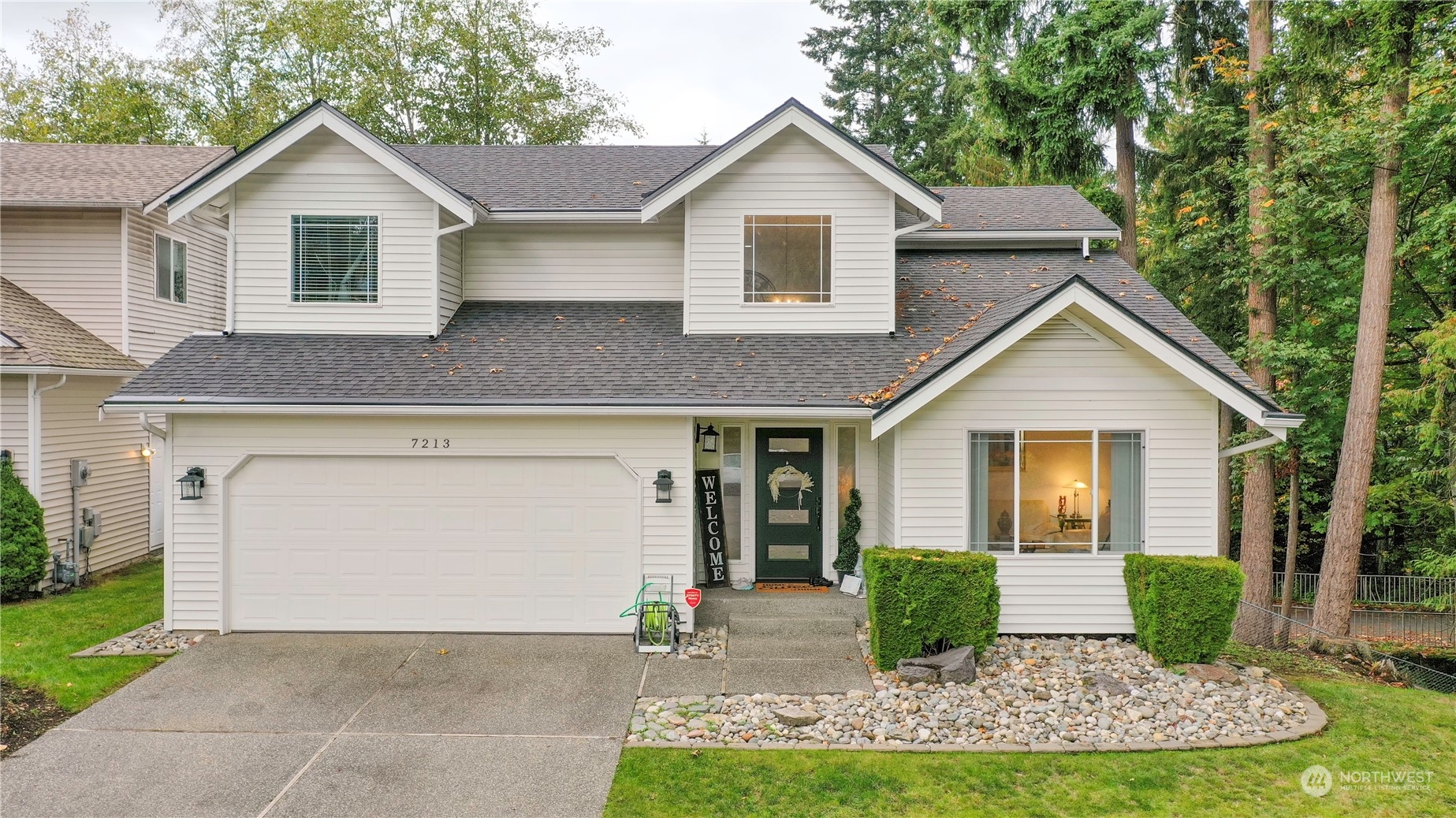 a front view of house with yard and green space