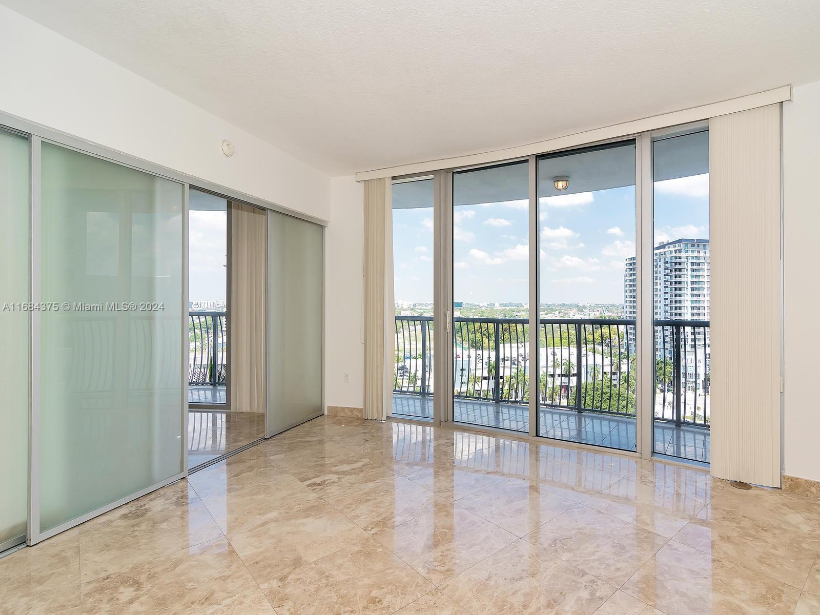 a view of an empty room with glass windows