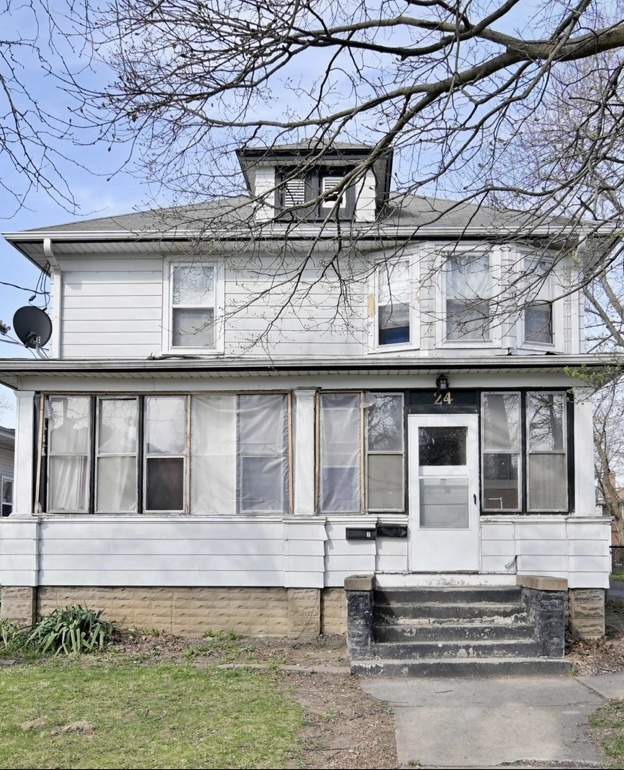 a large building with a small yard in front of it