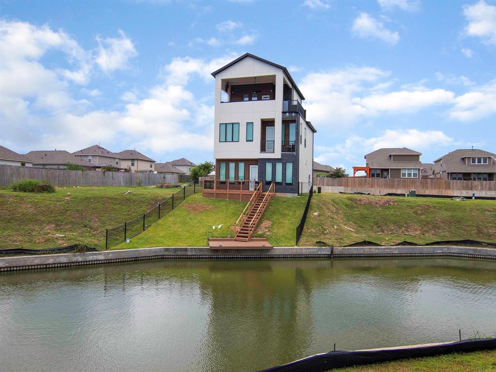 an aerial view of residential houses with lake view