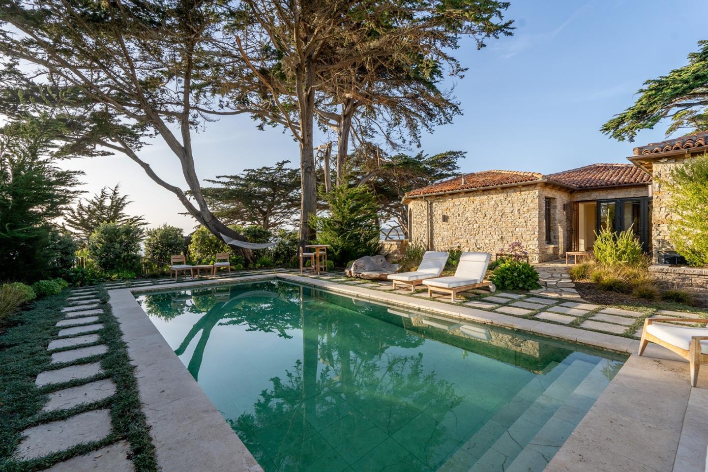 a house view with swimming pool and sitting area