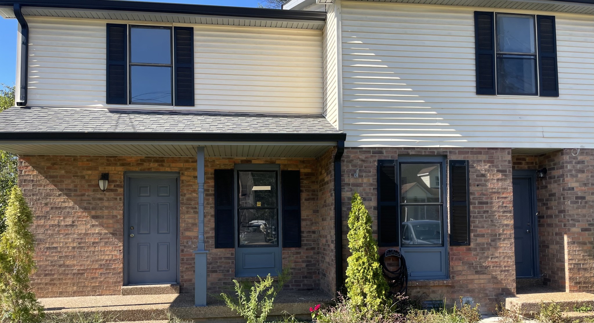 a view of a brick house with potted plants