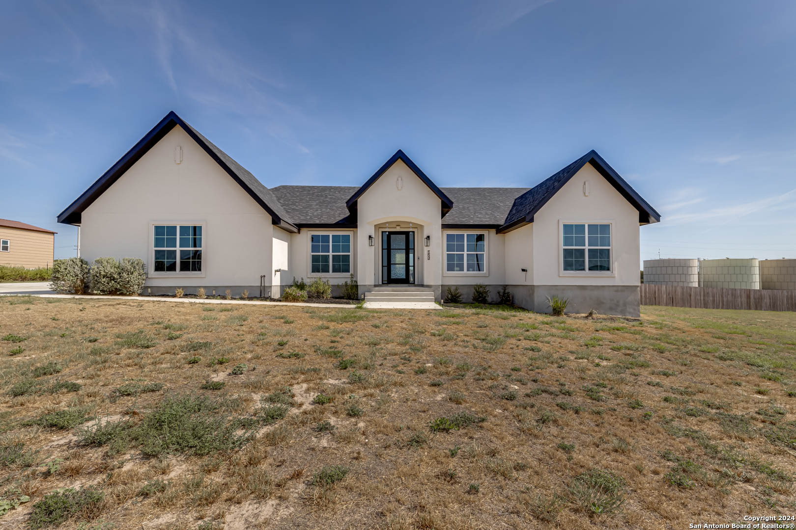 a front view of a house with a yard