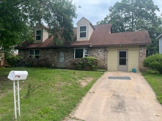 a front view of a house with a yard and a garden