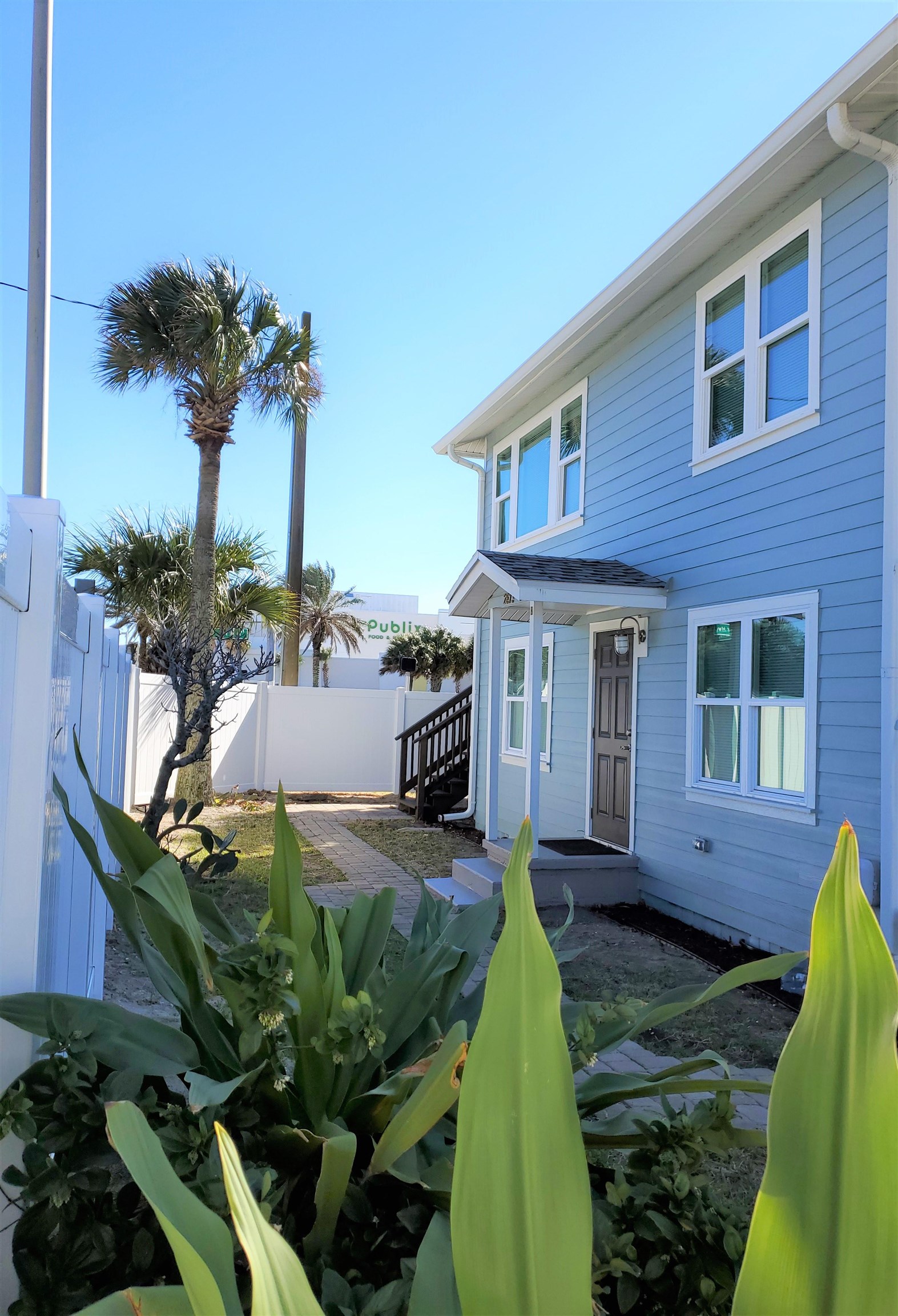 a view of a house with a yard patio and furniture