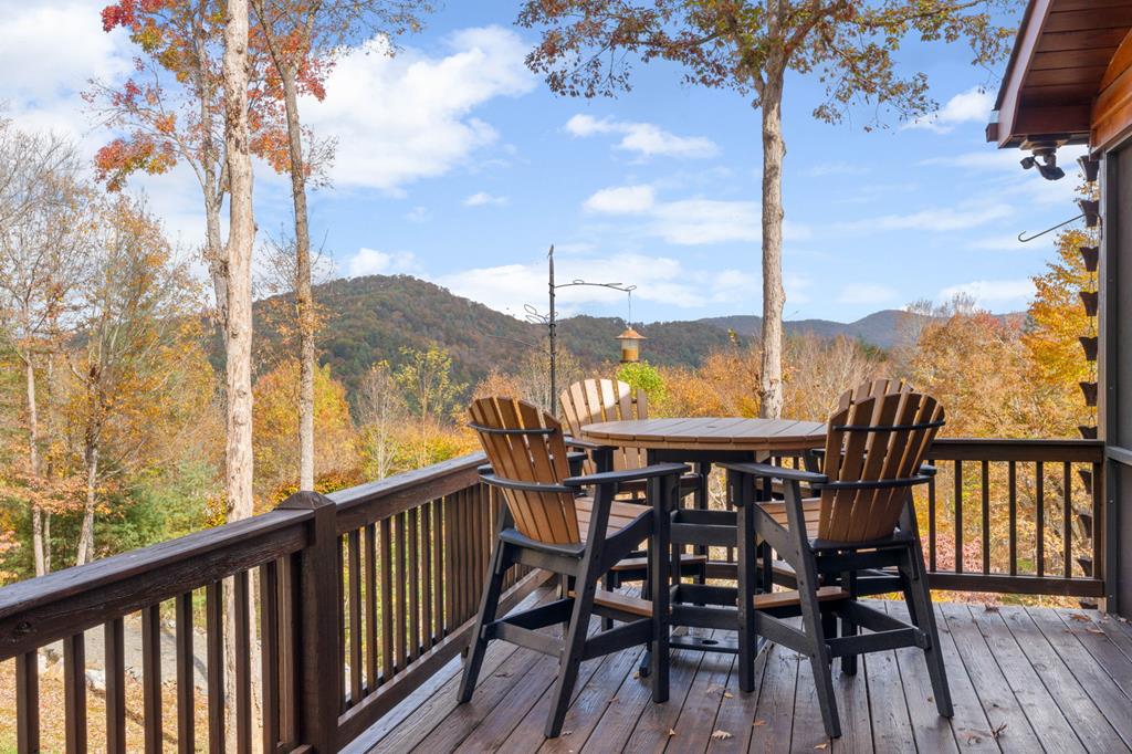 a view of a balcony with furniture and wooden floor