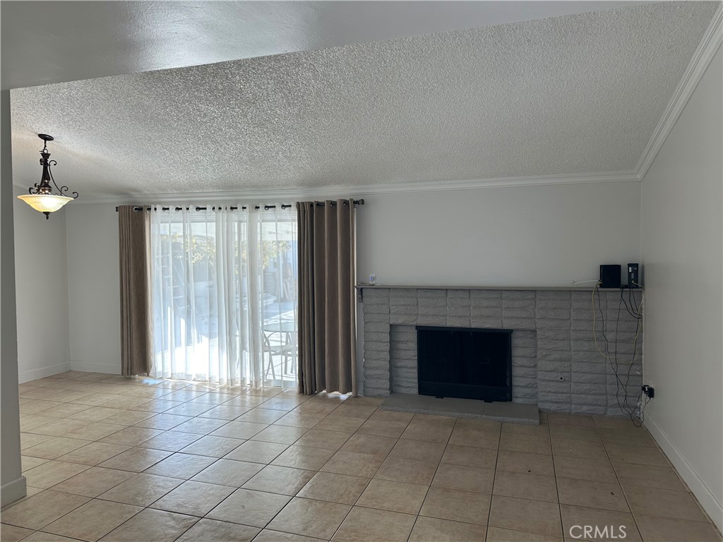 an empty room with windows and fireplace