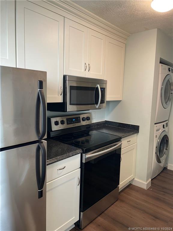 a kitchen with a refrigerator and a stove top oven