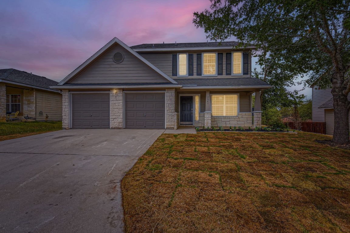 a front view of a house with a yard and garage