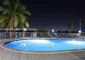 a view of swimming pool with outdoor seating and yard