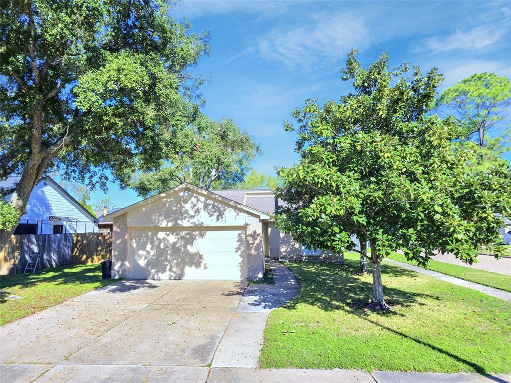 a front view of a house with a yard and a garden