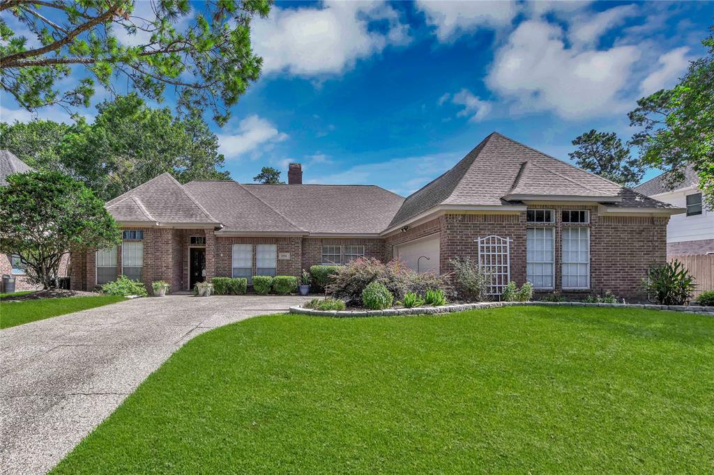 a front view of a house with a garden and yard