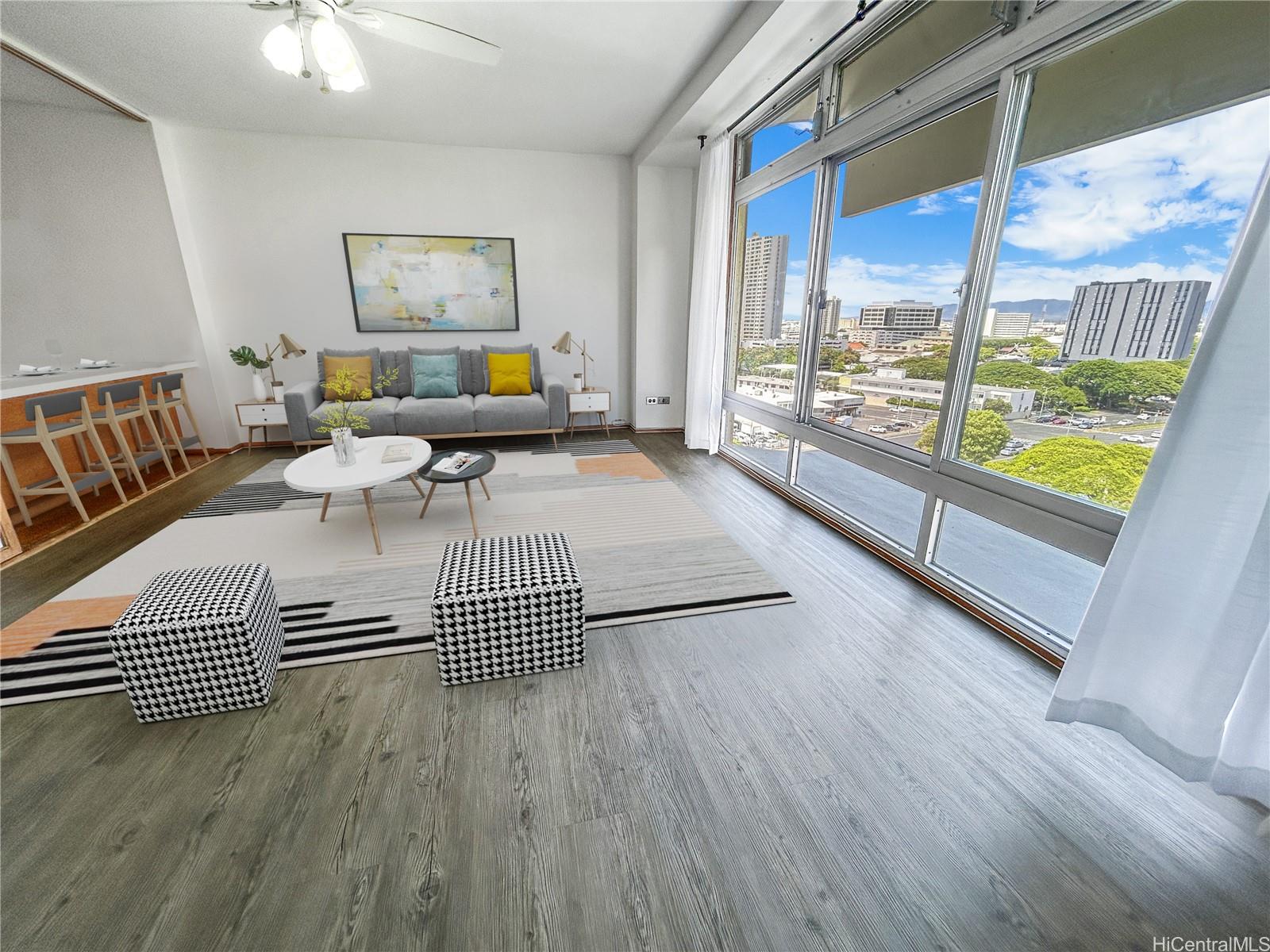 a living room with furniture and a floor to ceiling window