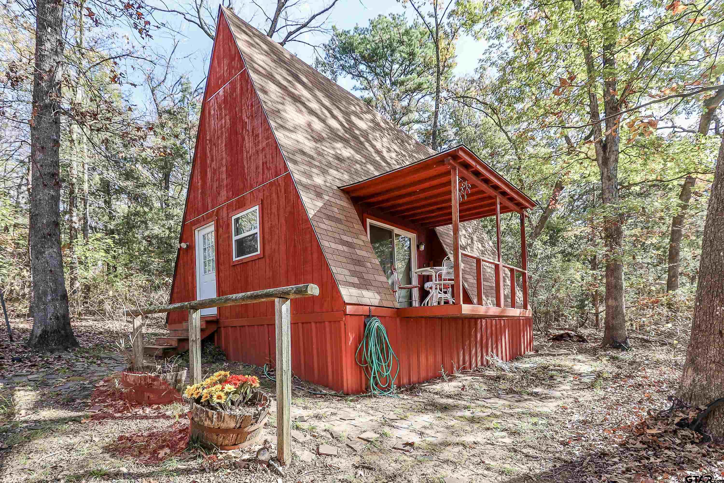 a view of a house with a yard and wooden fence