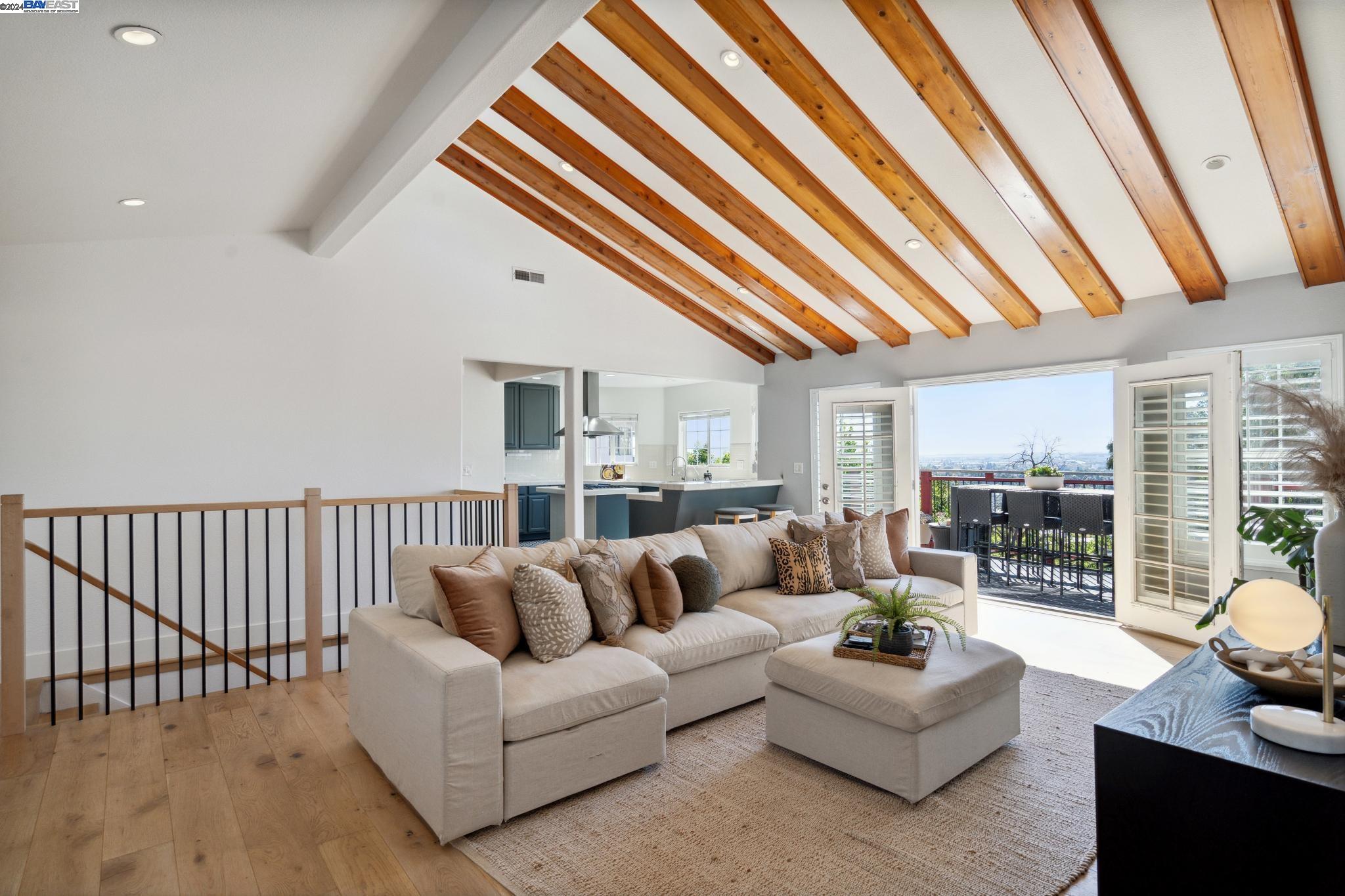 a living room with furniture and a floor to ceiling window