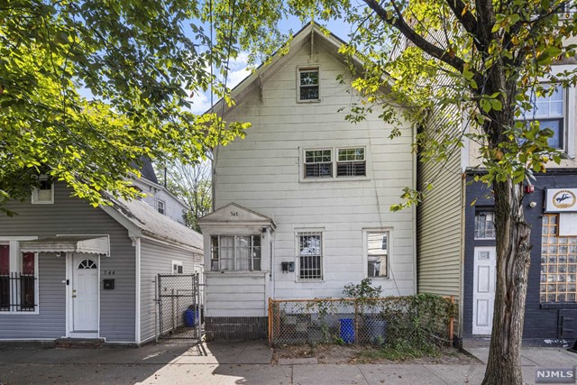 a view of a house with a tree