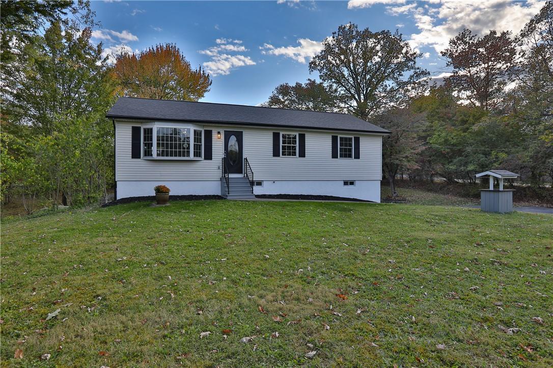 a front view of a house with a garden and yard