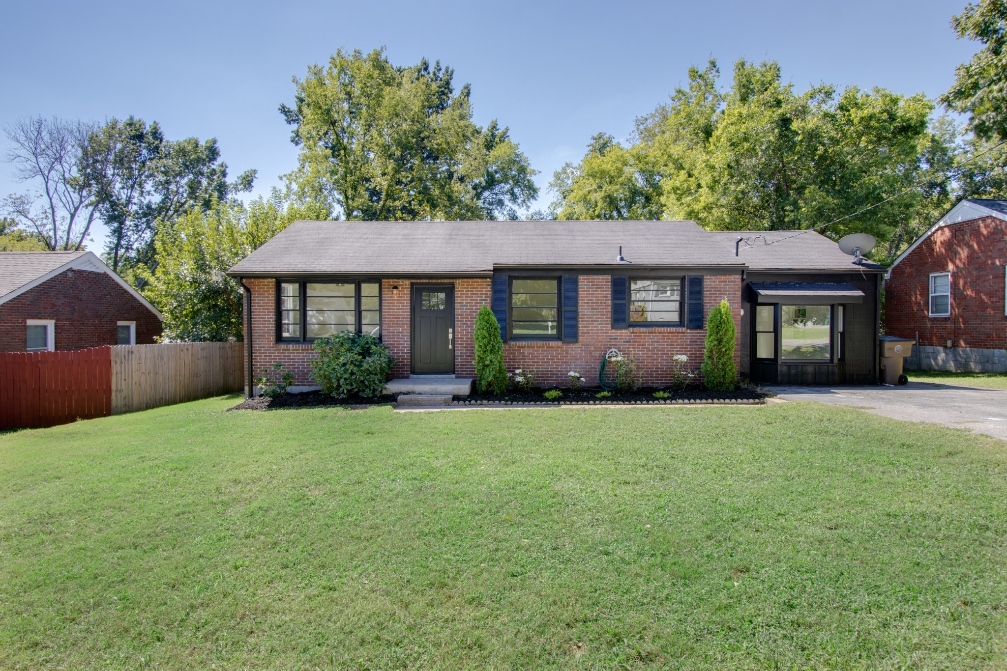 a front view of a house with a garden