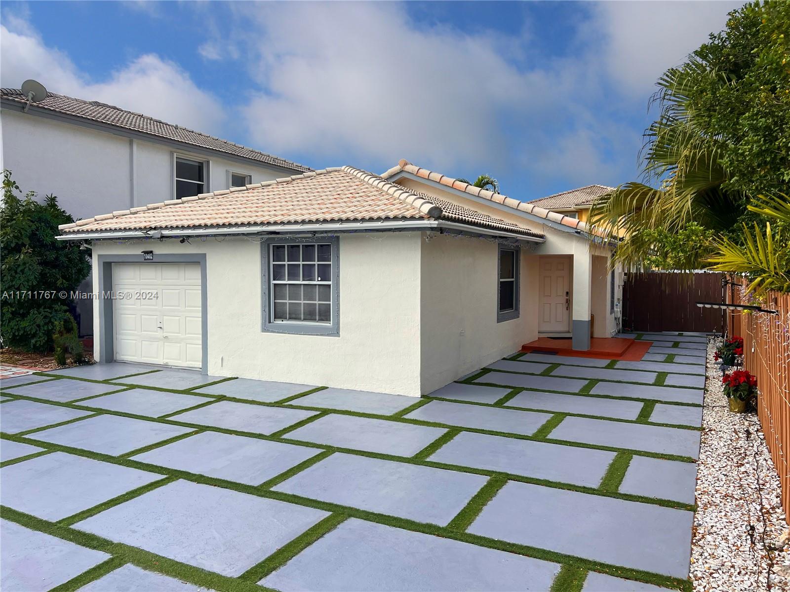 a front view of a house with garage