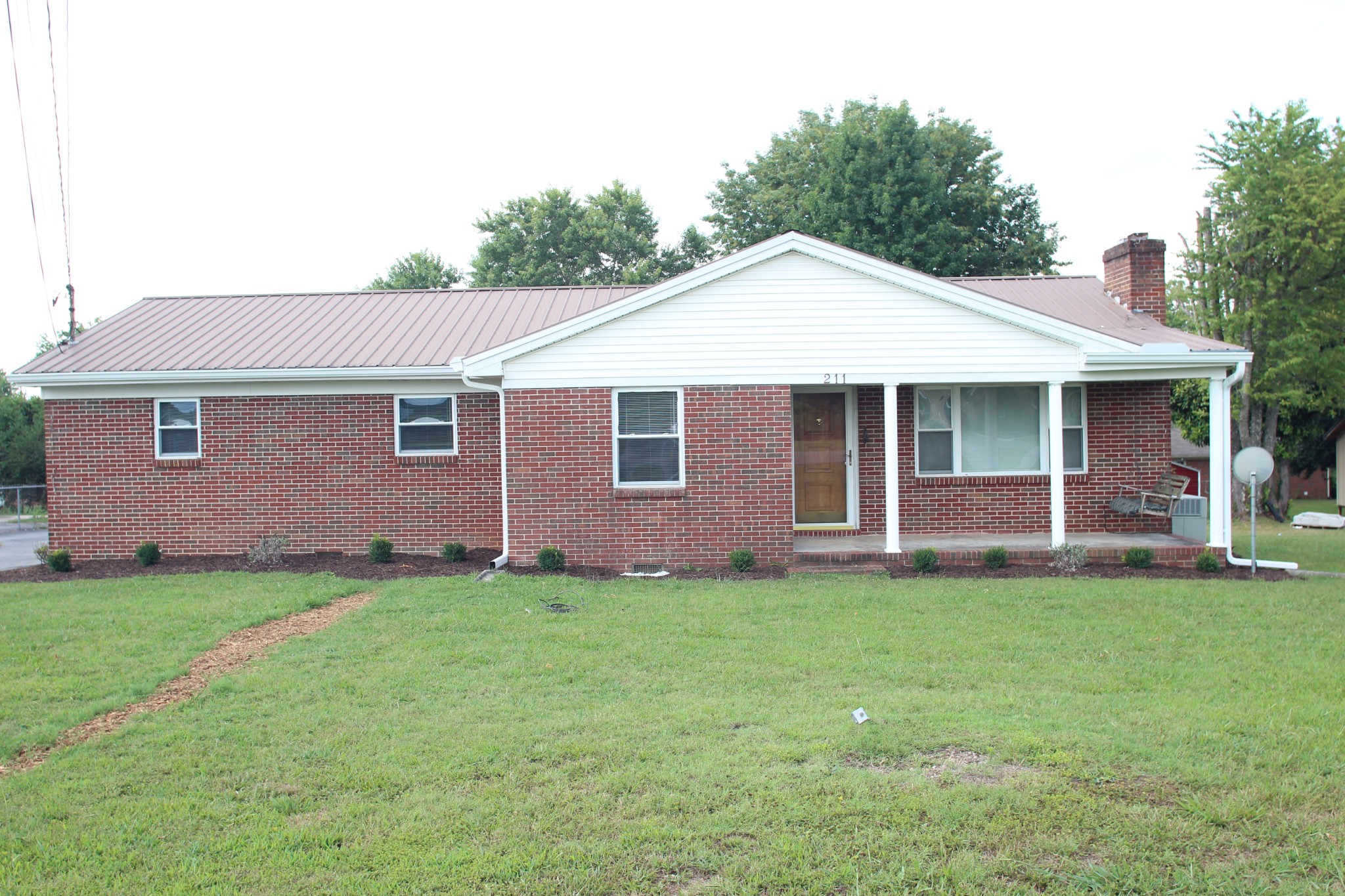 a front view of a house with a garden