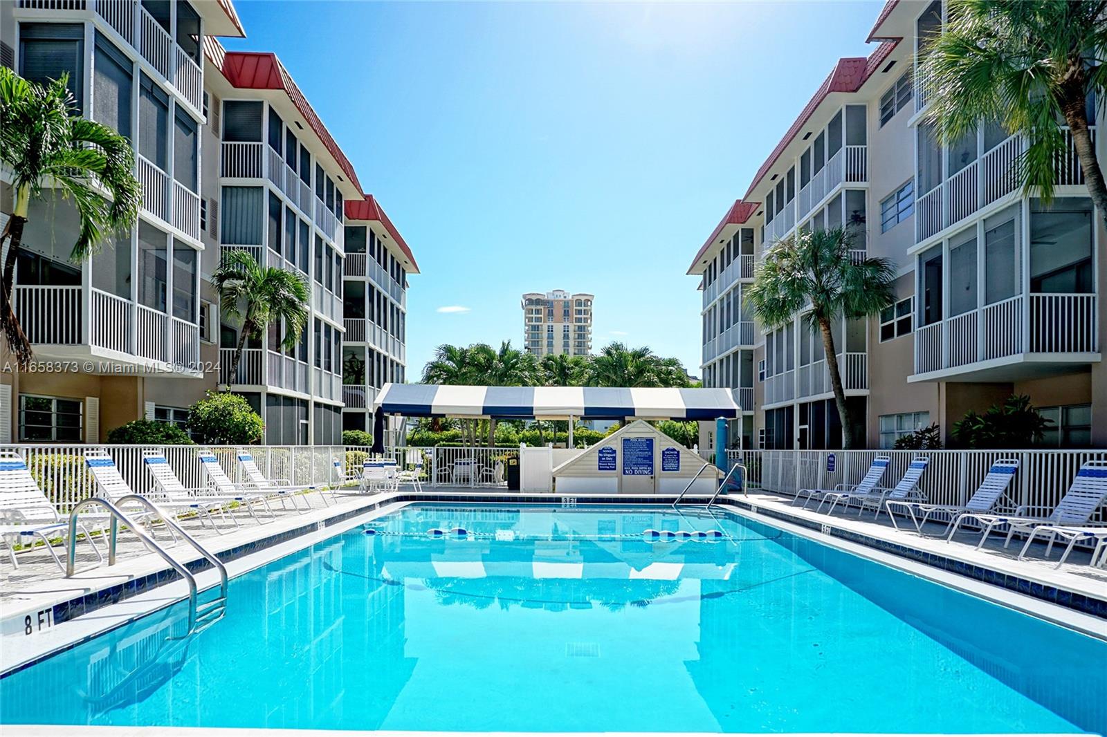 a view of a swimming pool with outdoor seating and a buildings