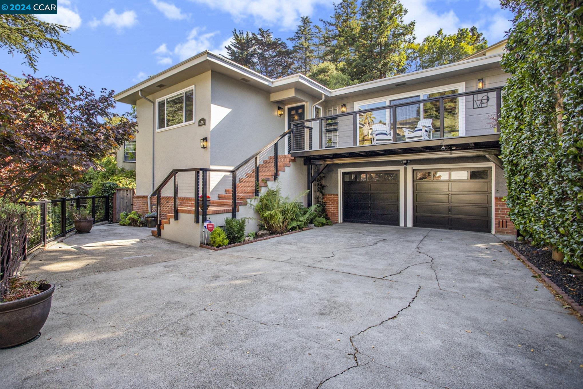 a front view of a house with a yard and a garage