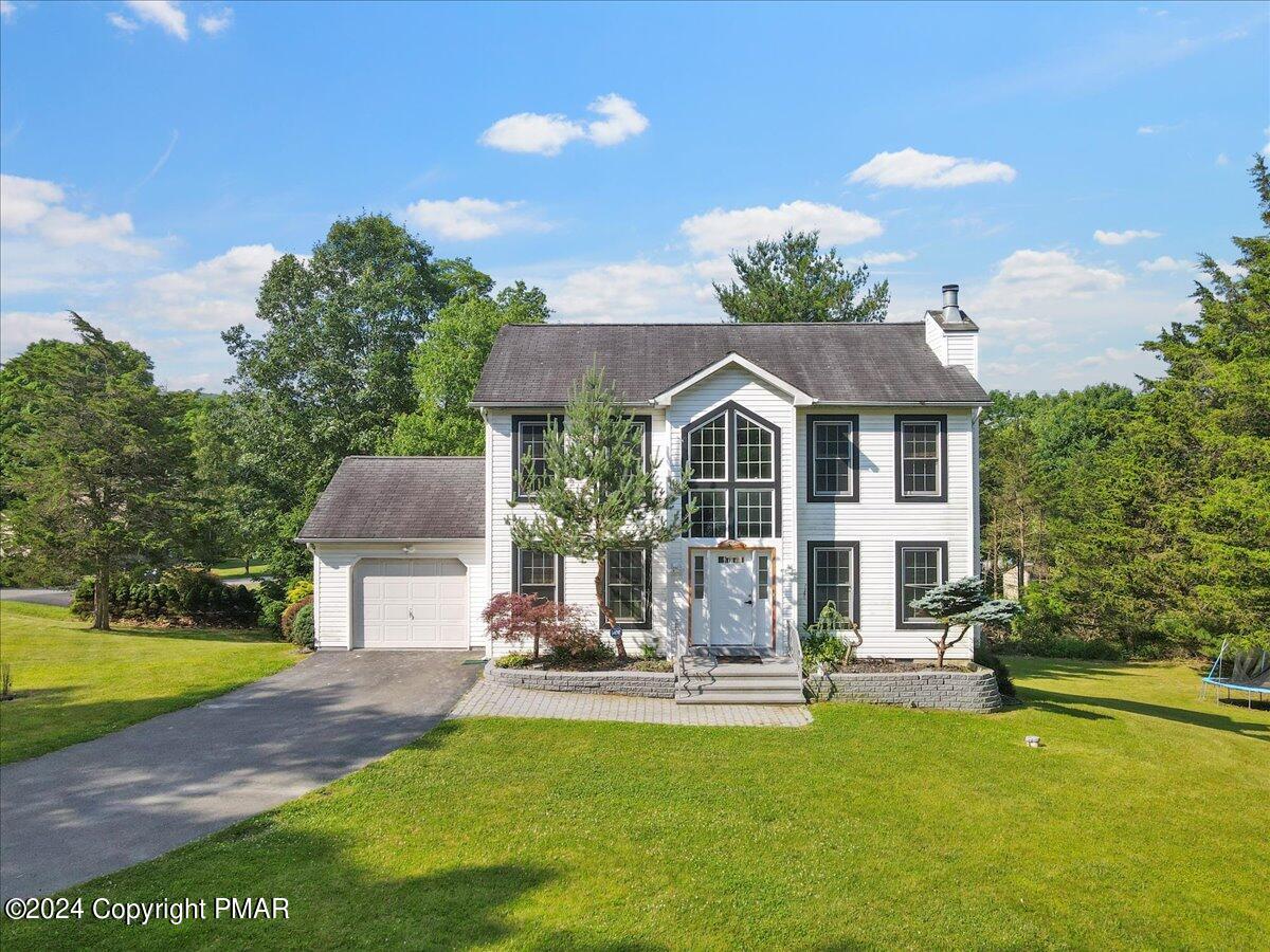 a view of a house with a yard porch and sitting area