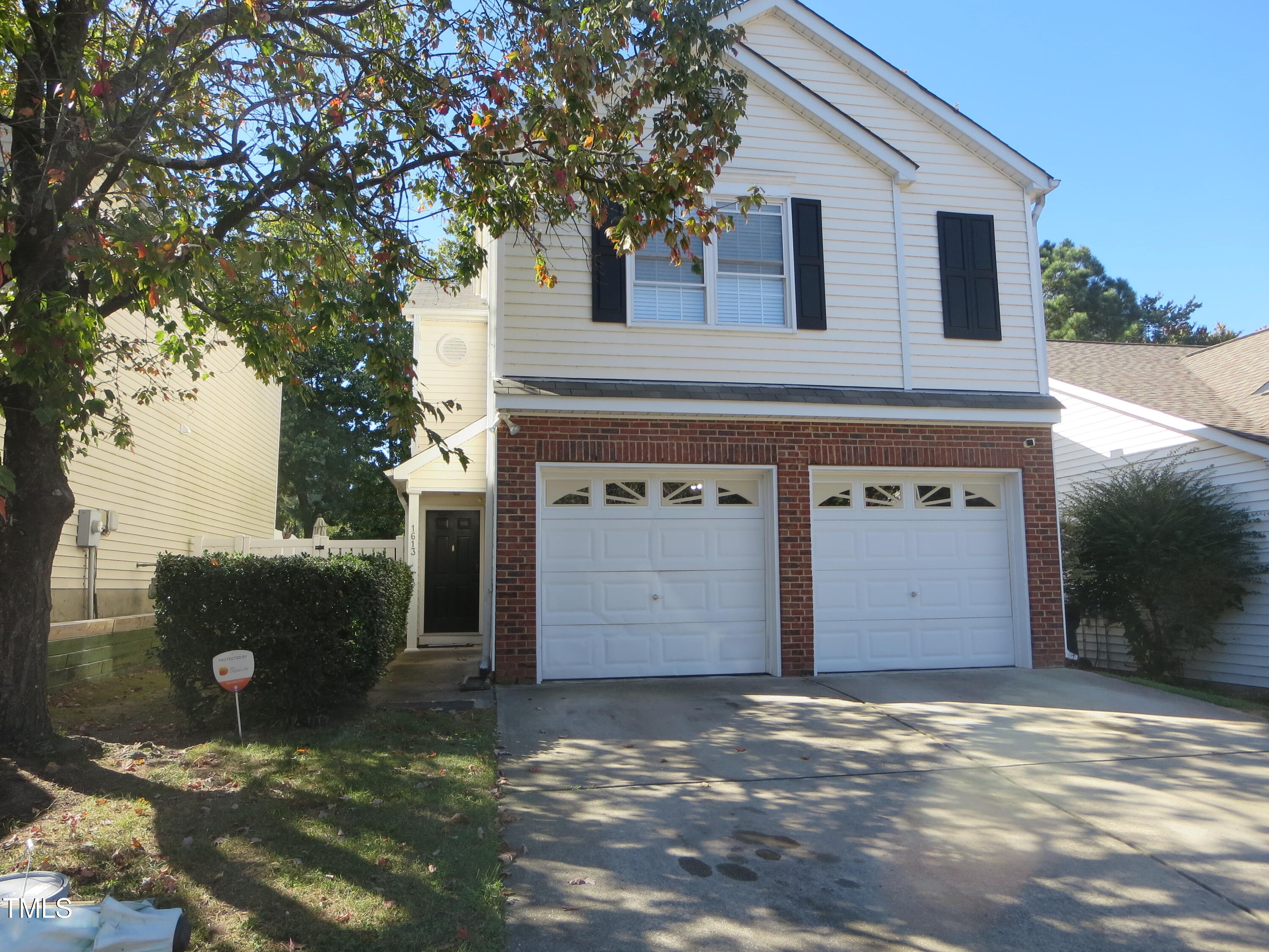 a front view of a house with a parking space